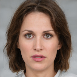 Joyful white young-adult female with medium  brown hair and green eyes