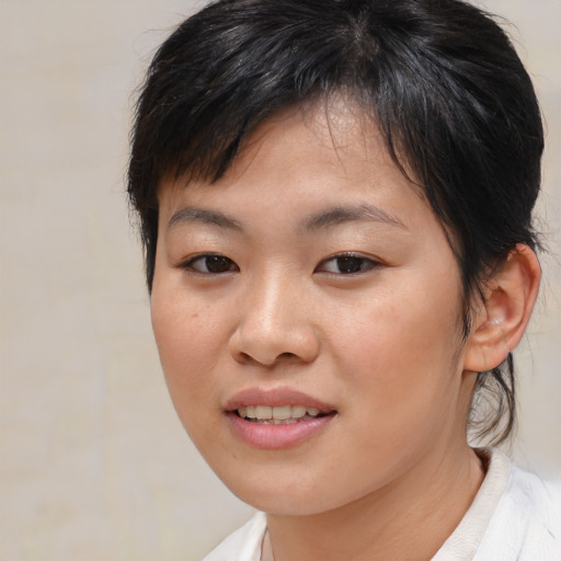 Joyful asian young-adult female with medium  brown hair and brown eyes