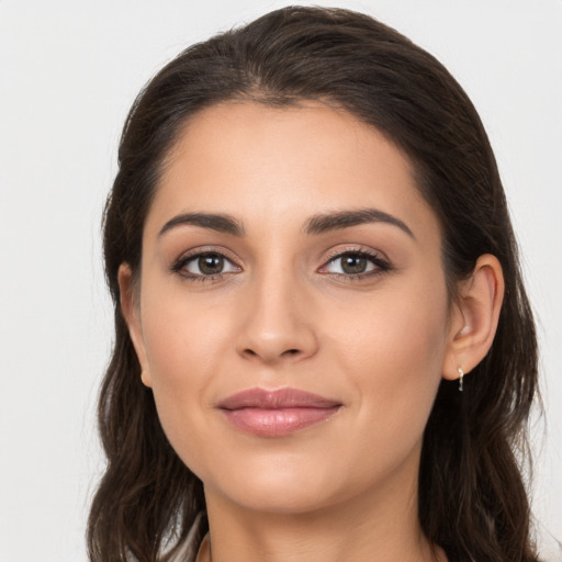 Joyful white young-adult female with long  brown hair and brown eyes