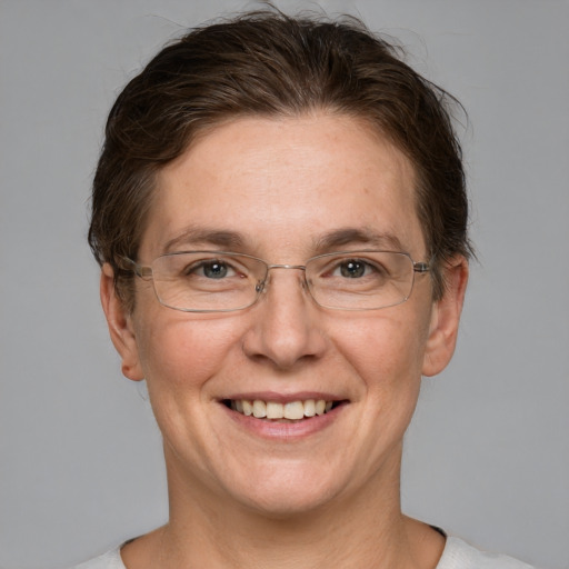 Joyful white adult female with short  brown hair and grey eyes