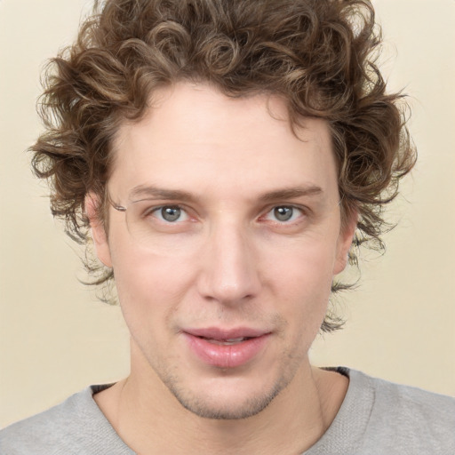 Joyful white young-adult male with short  brown hair and green eyes