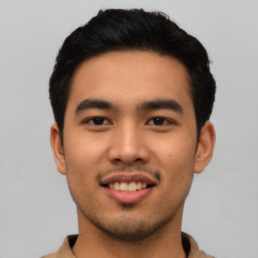 Joyful asian young-adult male with short  black hair and brown eyes
