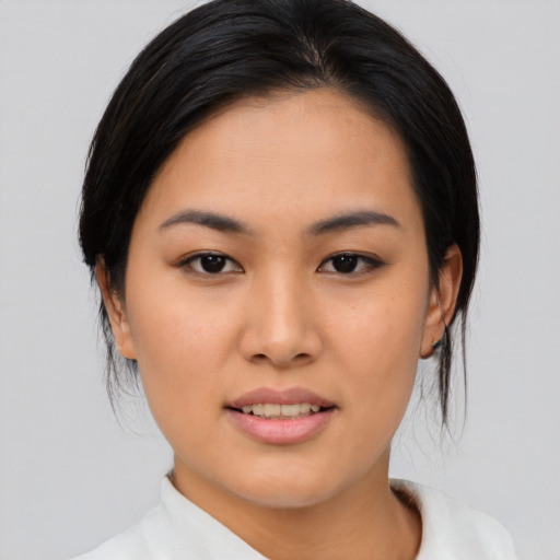 Joyful asian young-adult female with medium  black hair and brown eyes