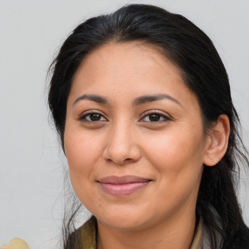 Joyful latino adult female with long  brown hair and brown eyes