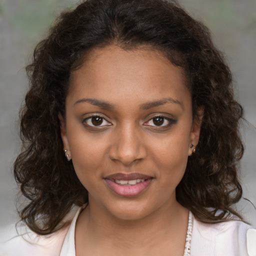 Joyful black young-adult female with medium  brown hair and brown eyes