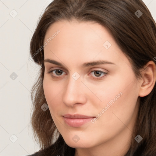 Neutral white young-adult female with long  brown hair and brown eyes