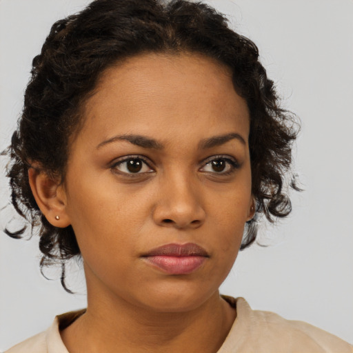 Neutral black young-adult female with medium  brown hair and brown eyes