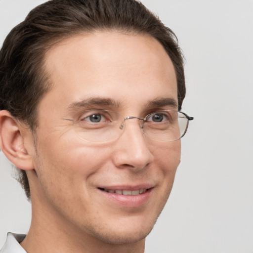 Joyful white adult male with short  brown hair and brown eyes