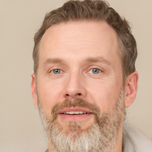 Joyful white adult male with short  brown hair and grey eyes