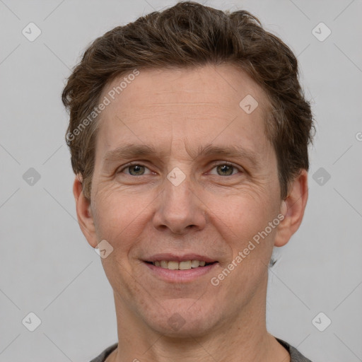 Joyful white adult male with short  brown hair and grey eyes