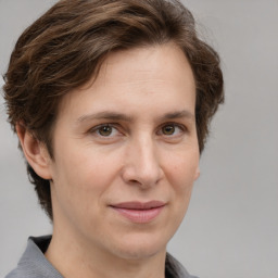 Joyful white adult female with medium  brown hair and grey eyes