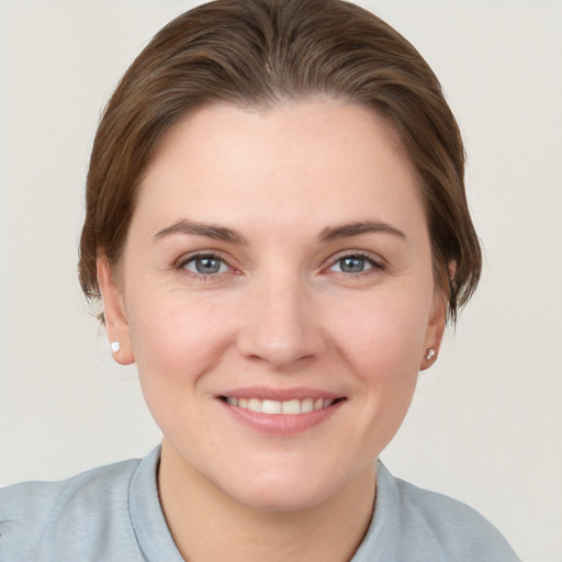 Joyful white young-adult female with short  brown hair and grey eyes