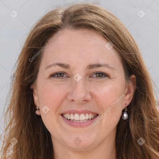 Joyful white adult female with long  brown hair and grey eyes