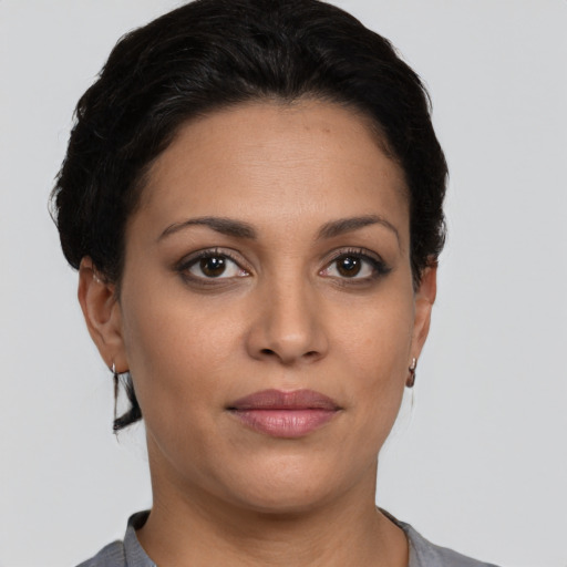 Joyful latino young-adult female with short  brown hair and brown eyes