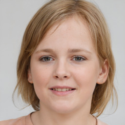 Joyful white child female with medium  brown hair and blue eyes