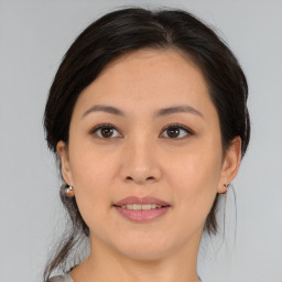 Joyful asian young-adult female with medium  brown hair and brown eyes