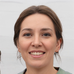 Joyful white young-adult female with medium  brown hair and grey eyes