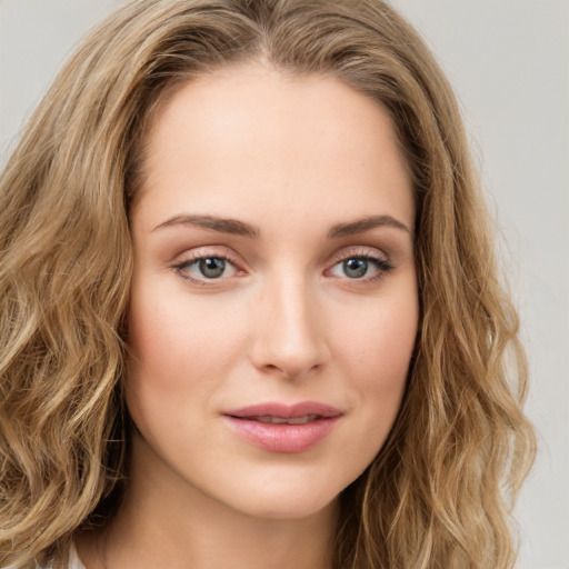 Joyful white young-adult female with long  brown hair and green eyes