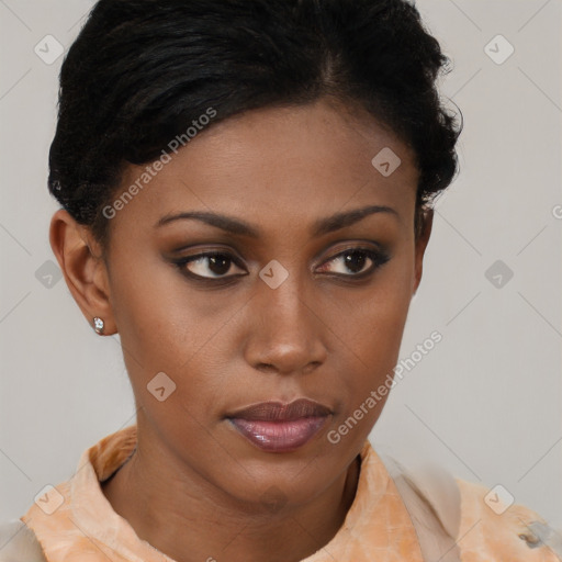 Joyful black young-adult female with short  brown hair and brown eyes