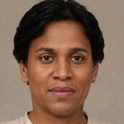 Joyful black adult female with short  brown hair and brown eyes