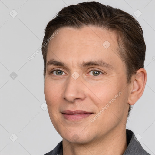 Joyful white adult male with short  brown hair and grey eyes