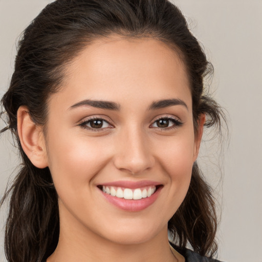 Joyful white young-adult female with long  brown hair and brown eyes