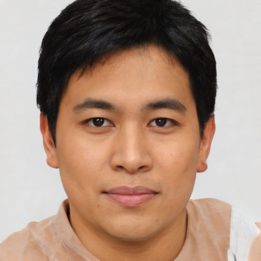 Joyful asian young-adult male with short  black hair and brown eyes