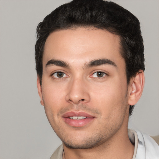 Joyful white young-adult male with short  black hair and brown eyes