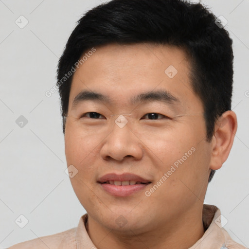 Joyful asian young-adult male with short  black hair and brown eyes