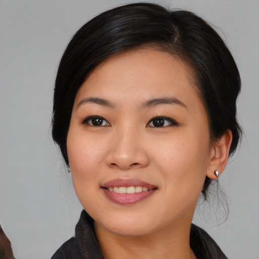 Joyful asian young-adult female with medium  black hair and brown eyes