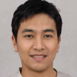 Joyful asian young-adult male with short  black hair and brown eyes