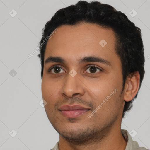 Joyful latino young-adult male with short  black hair and brown eyes