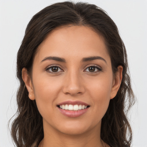 Joyful white young-adult female with long  brown hair and brown eyes