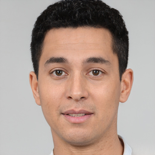 Joyful white young-adult male with short  black hair and brown eyes