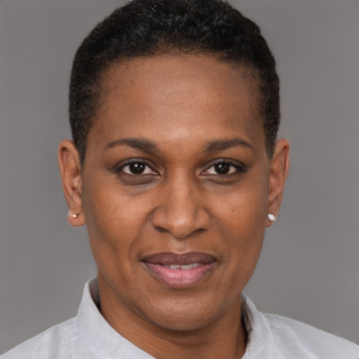 Joyful black adult female with short  brown hair and brown eyes