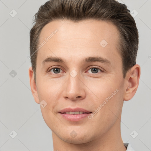 Joyful white young-adult male with short  brown hair and brown eyes