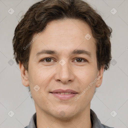 Joyful white adult male with short  brown hair and grey eyes