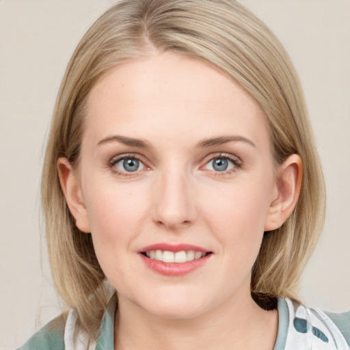 Joyful white young-adult female with medium  brown hair and blue eyes