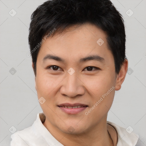 Joyful asian young-adult male with short  brown hair and brown eyes