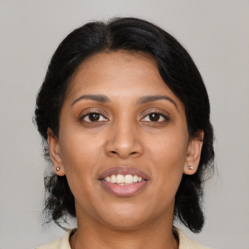 Joyful black young-adult female with medium  black hair and brown eyes