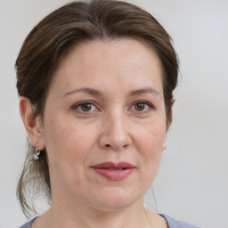 Joyful white adult female with medium  brown hair and grey eyes