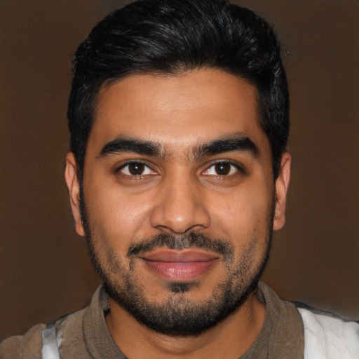 Joyful latino young-adult male with short  black hair and brown eyes
