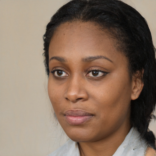 Joyful black young-adult female with medium  black hair and brown eyes