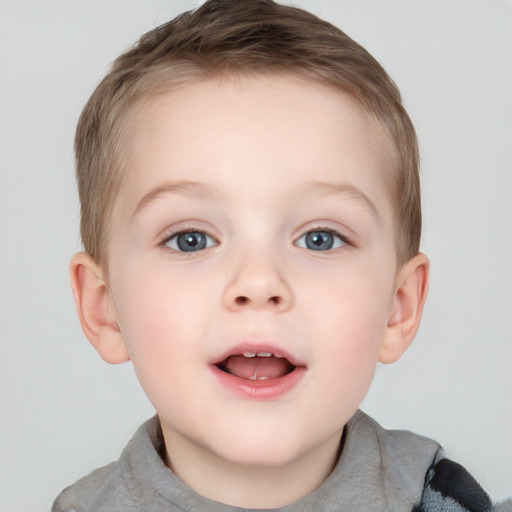 Joyful white child male with short  brown hair and grey eyes