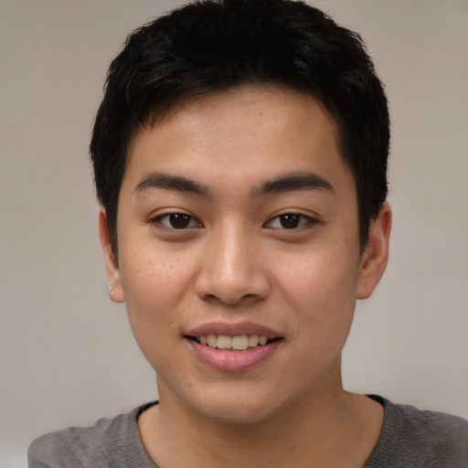 Joyful asian young-adult male with short  brown hair and brown eyes