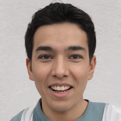 Joyful white young-adult male with short  black hair and brown eyes