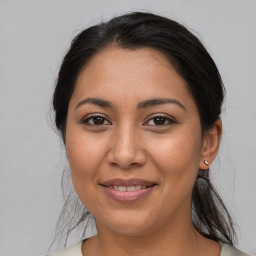 Joyful latino young-adult female with medium  brown hair and brown eyes