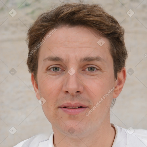 Joyful white adult male with short  brown hair and grey eyes