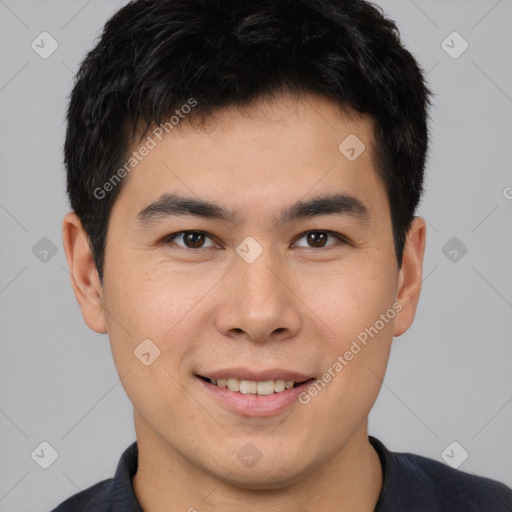 Joyful asian young-adult male with short  brown hair and brown eyes