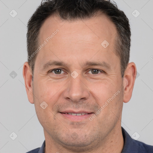 Joyful white adult male with short  brown hair and brown eyes